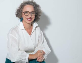 Christine Maria Kaltenleitner sitzt im Sommer in weisser Bluse auf einem Stuhl. Referentin des MC Lago Webinars «Der unterschätzte Erfolgsfaktor: Selbstwertgefühl» am 24. August 2026.